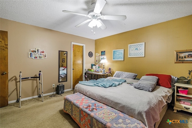 carpeted bedroom with a textured ceiling and ceiling fan