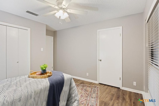 bedroom with wood finished floors, baseboards, and ceiling fan
