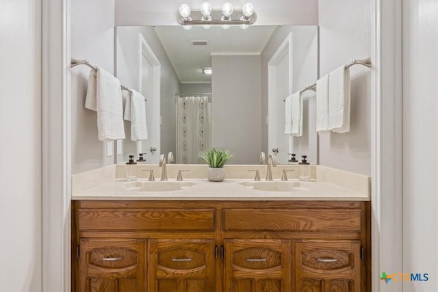 full bathroom with double vanity and crown molding