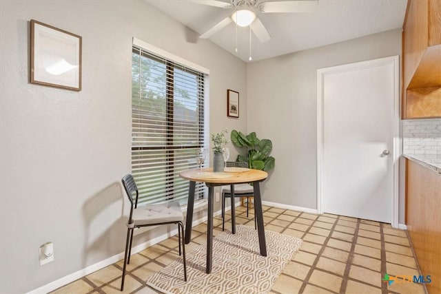 dining room with a ceiling fan and baseboards