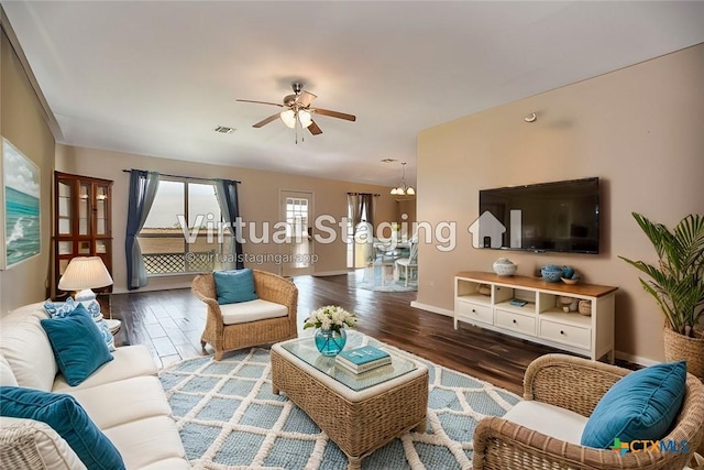 living area with a ceiling fan, baseboards, visible vents, and wood finished floors