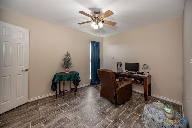 office space featuring ceiling fan, baseboards, and wood finish floors