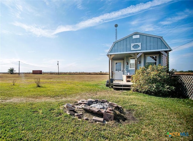 exterior space featuring a fire pit and a front lawn