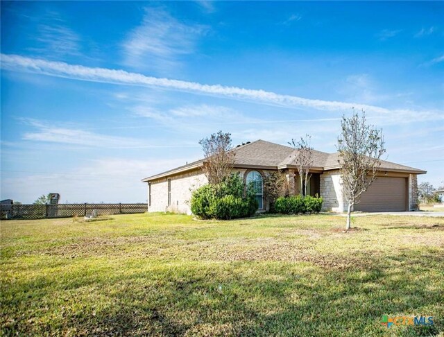 single story home with a garage, fence, a front lawn, and concrete driveway