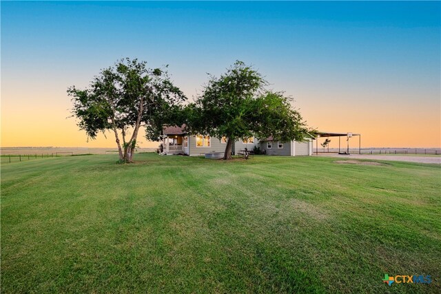 view of yard at dusk