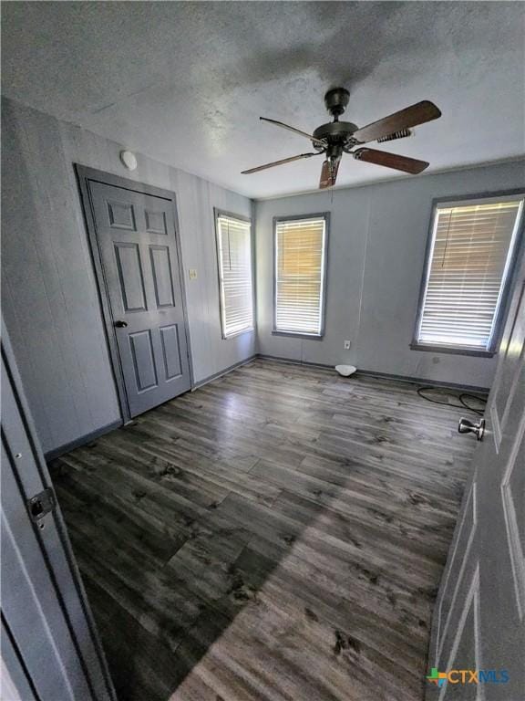 105 E Leon St, Gatesville, TX 76528 - interior space with a textured ceiling, ceiling fan, and dark wood finished floors