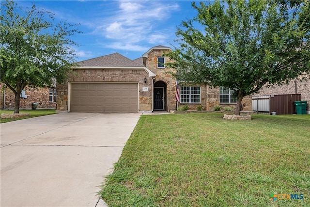 822 Old World Dr, Harker Heights, TX 76548 - traditional-style home featuring a garage, driveway, a front lawn, and stone siding