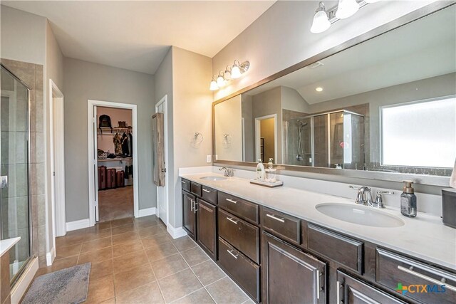 822 Old World Dr, Harker Heights, TX 76548 - bathroom with a shower stall, tile patterned floors, double vanity, and a spacious closet