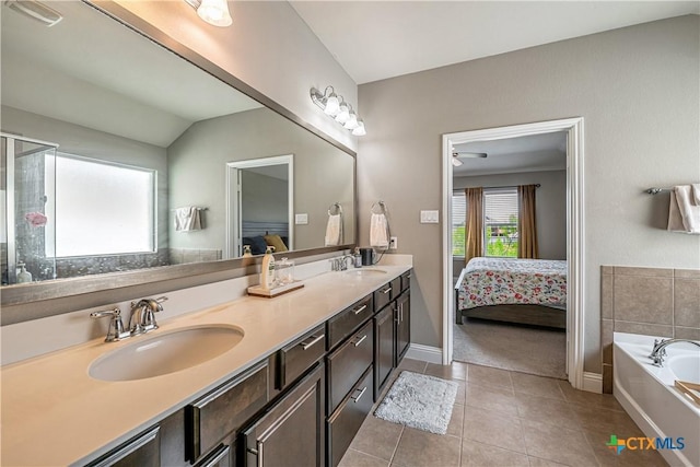 822 Old World Dr, Harker Heights, TX 76548 - full bath featuring ensuite bathroom, double vanity, tile patterned floors, a garden tub, and vaulted ceiling