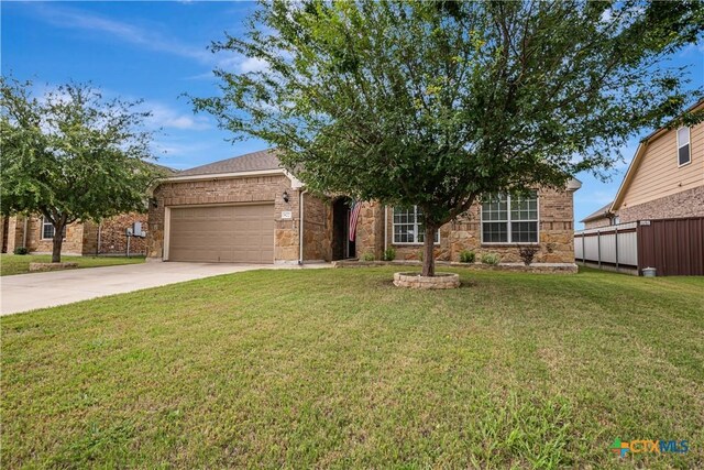 822 Old World Dr, Harker Heights, TX 76548 - obstructed view of property featuring driveway, a garage, a front yard, and stone siding