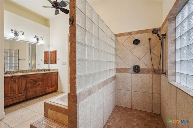 bathroom featuring shower with separate bathtub, ceiling fan, tile patterned flooring, and vanity