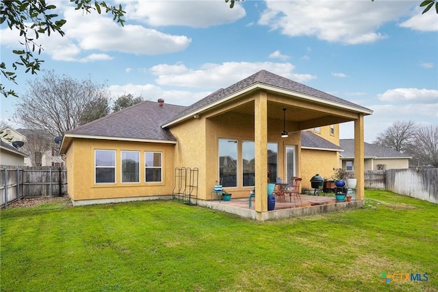 rear view of property featuring a patio area and a lawn