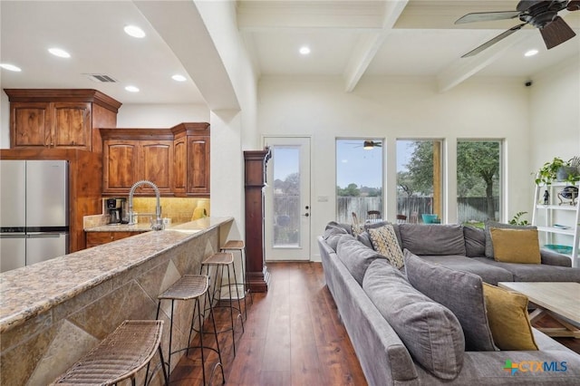 living room featuring ceiling fan, coffered ceiling, beamed ceiling, sink, and dark hardwood / wood-style floors