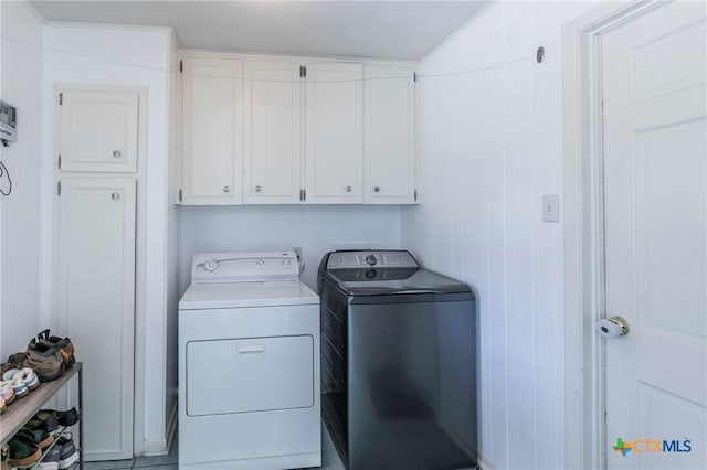 laundry area with cabinets and washing machine and dryer