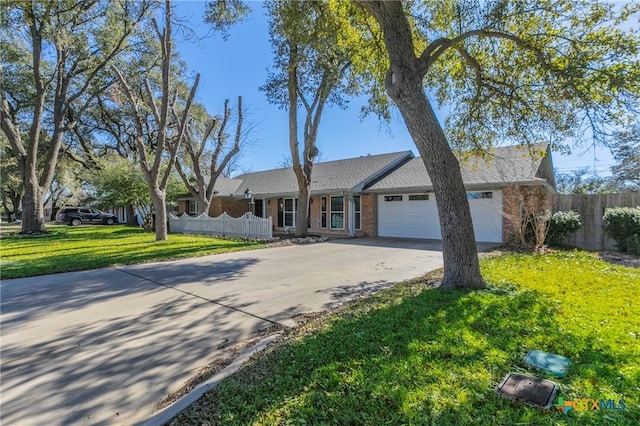 single story home featuring a garage and a front yard