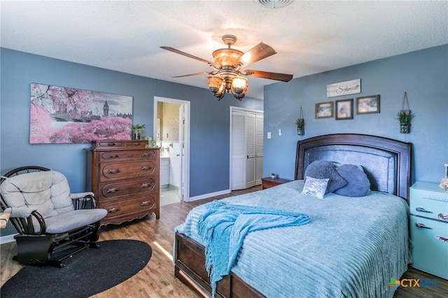 bedroom featuring ensuite bath, ceiling fan, a textured ceiling, light wood-type flooring, and a closet