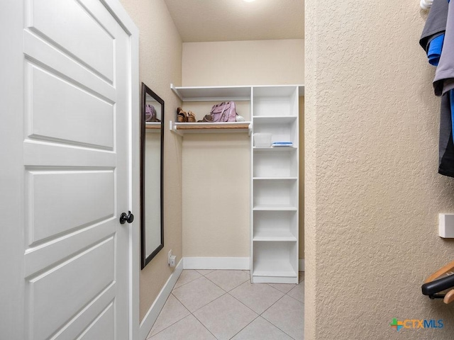 spacious closet with light tile patterned floors