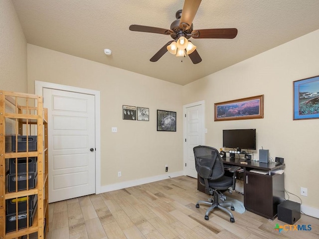 office featuring light wood finished floors, a ceiling fan, and baseboards