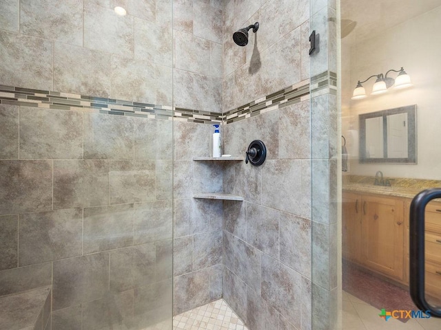 interior details featuring tiled shower and a sink