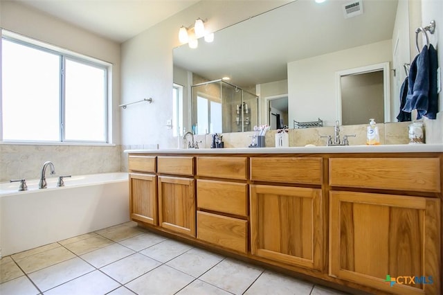 2406 Peace Pipe Cir, Copperas Cove, TX 76522 - bathroom featuring double vanity, tile patterned floors, a shower stall, and a garden tub