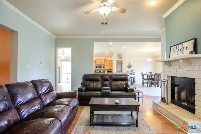 2406 Peace Pipe Cir, Copperas Cove, TX 76522 - living area with wood finished floors, ceiling fan, a fireplace, ornamental molding, and baseboards