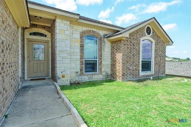 2406 Peace Pipe Cir, Copperas Cove, TX 76522 - property entrance with brick siding, a yard, and stone siding