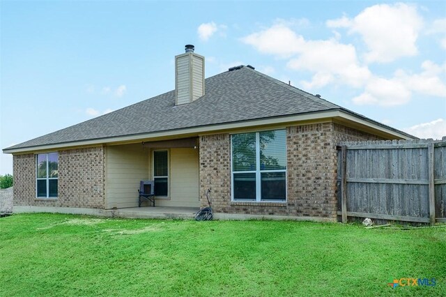 2406 Peace Pipe Cir, Copperas Cove, TX 76522 - back of house featuring brick siding, a patio, roof with shingles, and a chimney