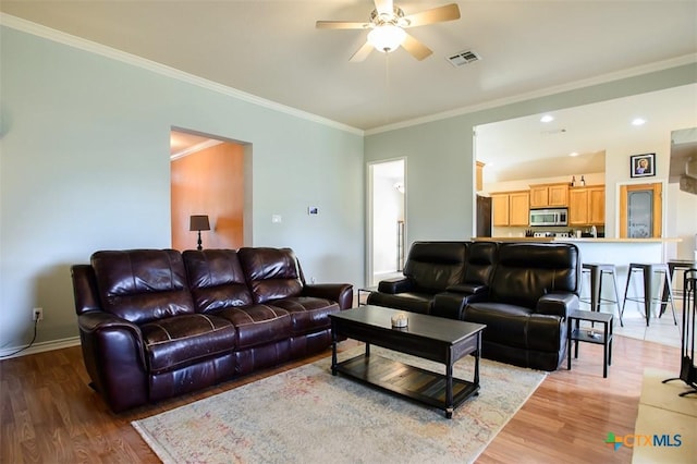 2406 Peace Pipe Cir, Copperas Cove, TX 76522 - living area with light wood-style flooring, a ceiling fan, ornamental molding, and baseboards
