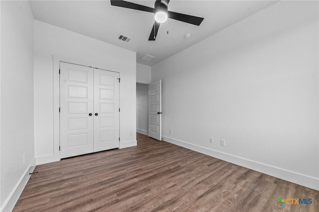 unfurnished bedroom featuring a closet, ceiling fan, and hardwood / wood-style flooring