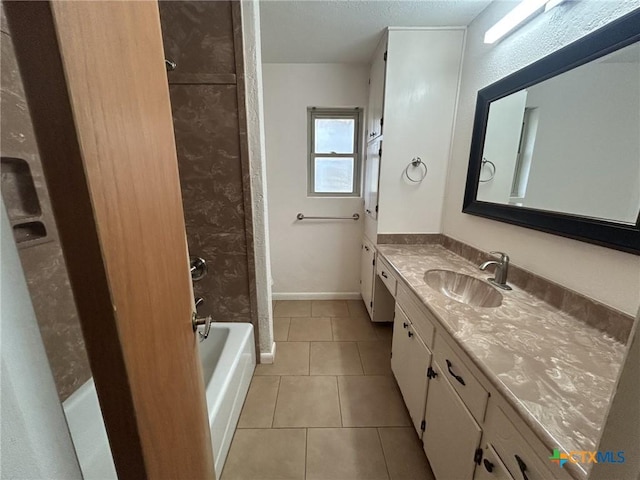 bathroom featuring tile patterned flooring, baseboards, shower / washtub combination, and vanity