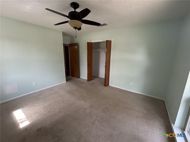 unfurnished bedroom featuring visible vents, a textured ceiling, and baseboards