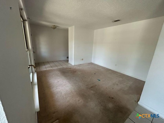 unfurnished room featuring visible vents and a textured ceiling