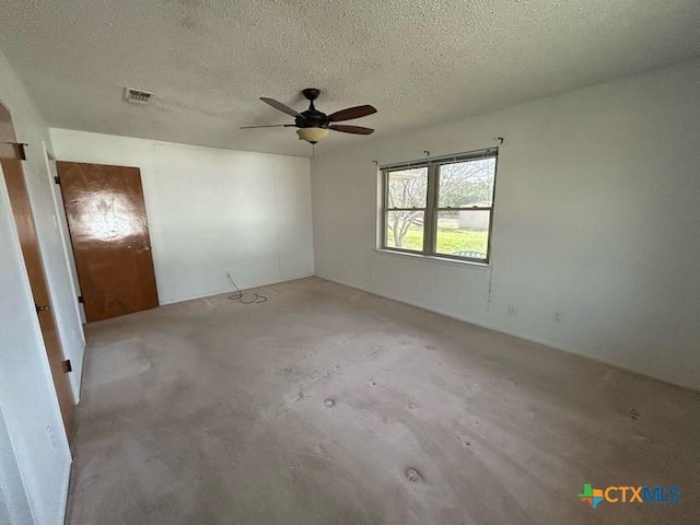 unfurnished bedroom with concrete flooring, visible vents, ceiling fan, and a textured ceiling