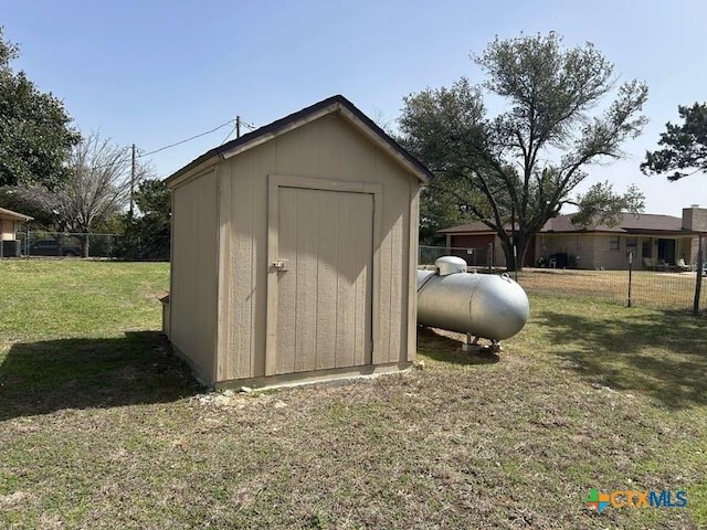 view of shed featuring fence