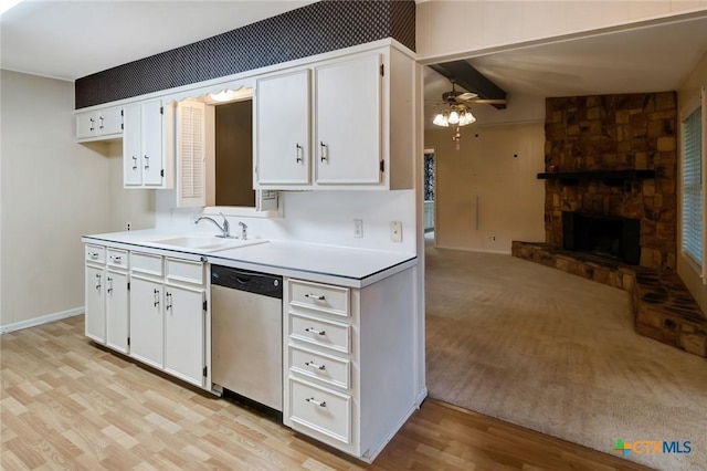 304 Simpson Rd, Victoria, TX 77904 - kitchen with stainless steel dishwasher, ceiling fan, light countertops, and white cabinetry