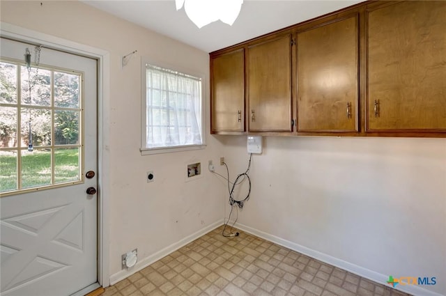 304 Simpson Rd, Victoria, TX 77904 - washroom with washer hookup, electric dryer hookup, cabinet space, and light flooring