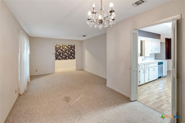 304 Simpson Rd, Victoria, TX 77904 - spare room featuring light carpet and a chandelier