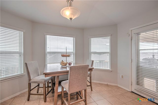 dining room featuring baseboards and light tile patterned floors