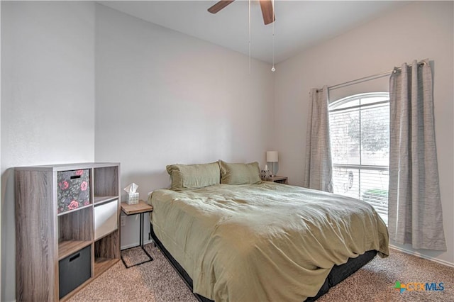 bedroom featuring multiple windows, a ceiling fan, and light colored carpet