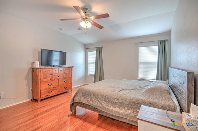 bedroom with lofted ceiling, ceiling fan, light wood-style flooring, and baseboards