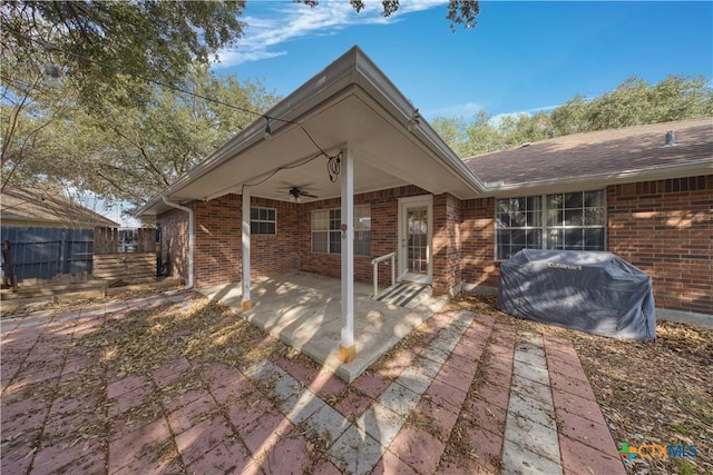607 Topaz Ave, Seguin, TX 78155 - rear view of house with ceiling fan, a patio area, and brick siding