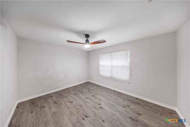 607 Topaz Ave, Seguin, TX 78155 - spare room featuring wood finished floors, baseboards, and ceiling fan
