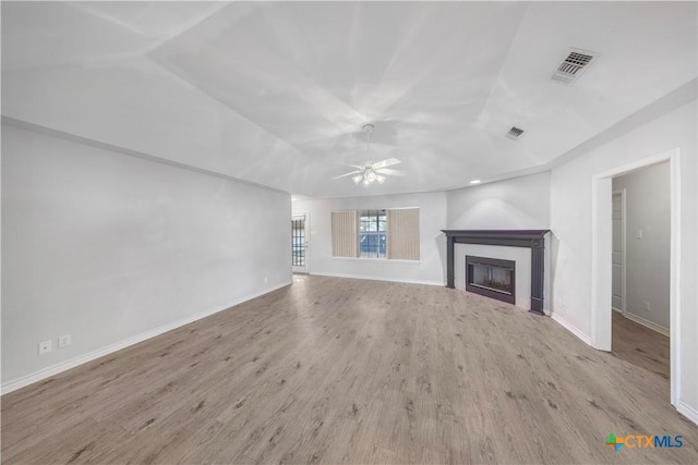 607 Topaz Ave, Seguin, TX 78155 - unfurnished living room featuring a ceiling fan, wood finished floors, a fireplace, baseboards, and vaulted ceiling