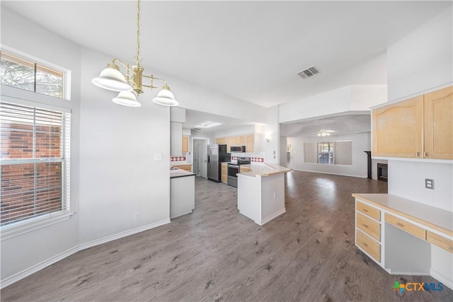 607 Topaz Ave, Seguin, TX 78155 - kitchen with open floor plan, light brown cabinets, stainless steel appliances, a chandelier, and light wood-style floors