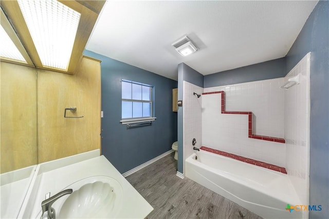 607 Topaz Ave, Seguin, TX 78155 - full bath featuring vanity, shower / tub combination, toilet, wood finished floors, and baseboards