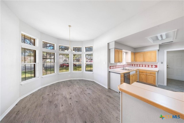 607 Topaz Ave, Seguin, TX 78155 - kitchen featuring a sink, wood finished floors, dishwasher, light countertops, and baseboards