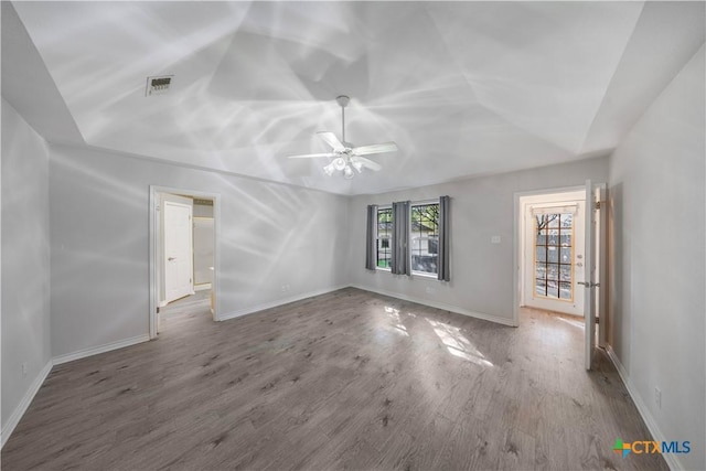 607 Topaz Ave, Seguin, TX 78155 - unfurnished living room featuring ceiling fan, wood finished floors, baseboards, and lofted ceiling