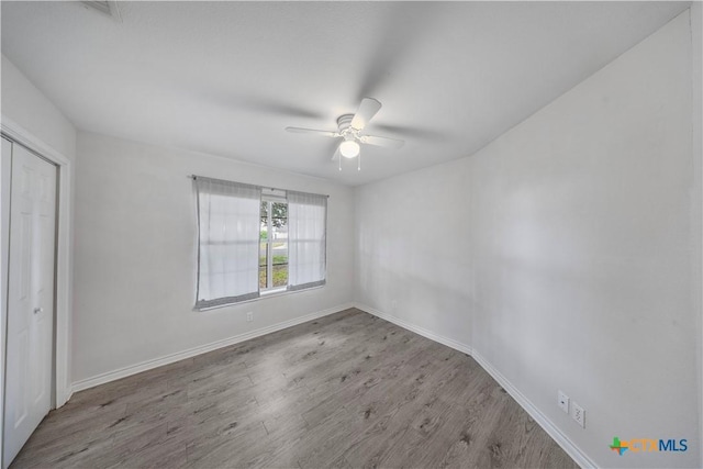 607 Topaz Ave, Seguin, TX 78155 - unfurnished bedroom with wood finished floors, a closet, baseboards, and a ceiling fan