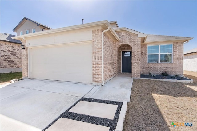 ranch-style house with brick siding, an attached garage, and driveway