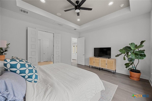 120 Diamondback Dr, Georgetown, TX 78628 - bedroom featuring a raised ceiling, wood finished floors, recessed lighting, baseboards, and ceiling fan